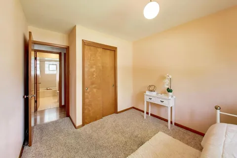 a bedroom with furniture and a window