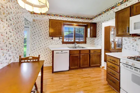 a kitchen with stainless steel appliances granite countertop a sink stove and oven