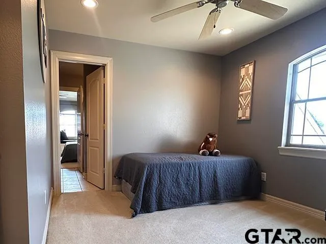 a bed room with a bed window and a chair