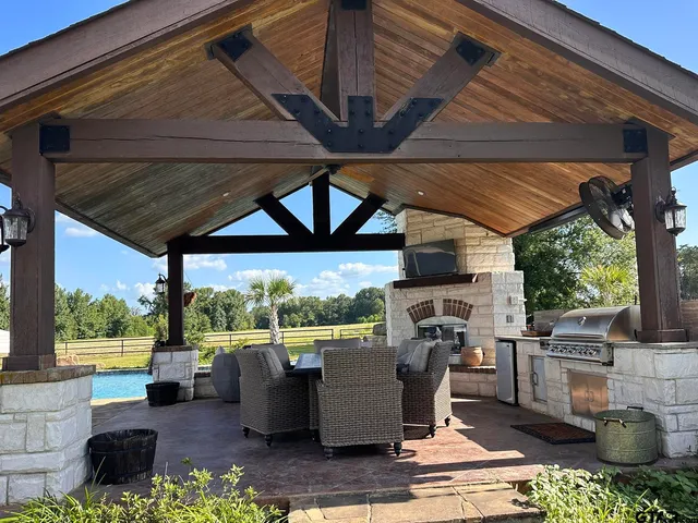 a outdoor space with patio the couches and a fireplace