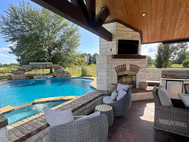 a view of a backyard with swimming pool