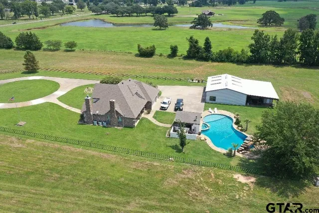 an aerial view of a house with garden space and street view