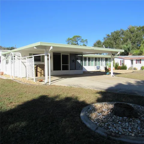 a front view of a house with two chairs
