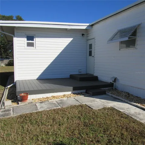 a view of empty room with wooden floor and fireplace