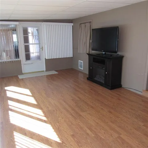 a view of a room with wooden floor and window