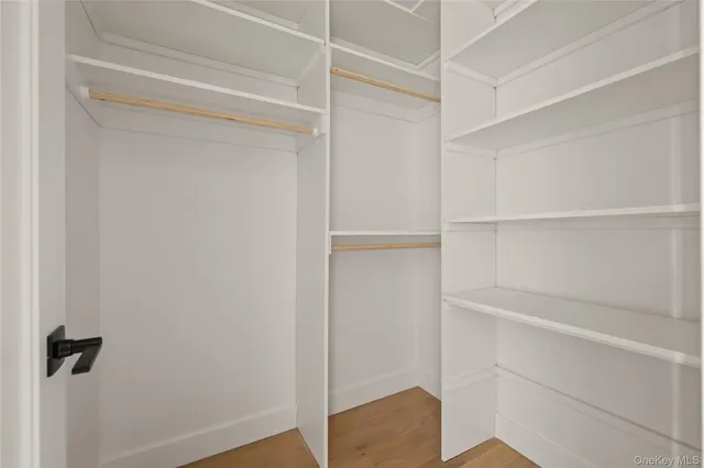 a white toilet sitting next to a white cabinet