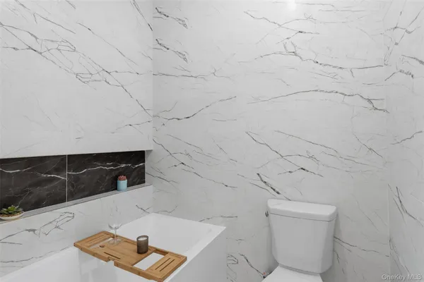 a bathroom with a toilet and shower