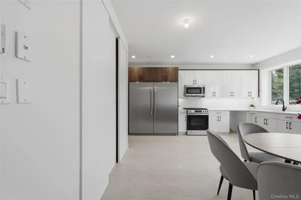 a large kitchen with a table and chairs