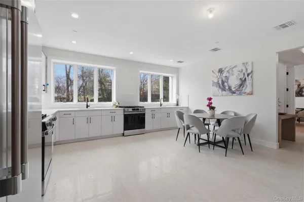 a large kitchen with a table and chairs