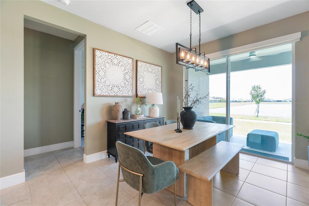 1634 Groveline Road St. Cloud, FL 34771 - Photo 18 of 43 a view of a dining room with furniture large windows and wooden floor