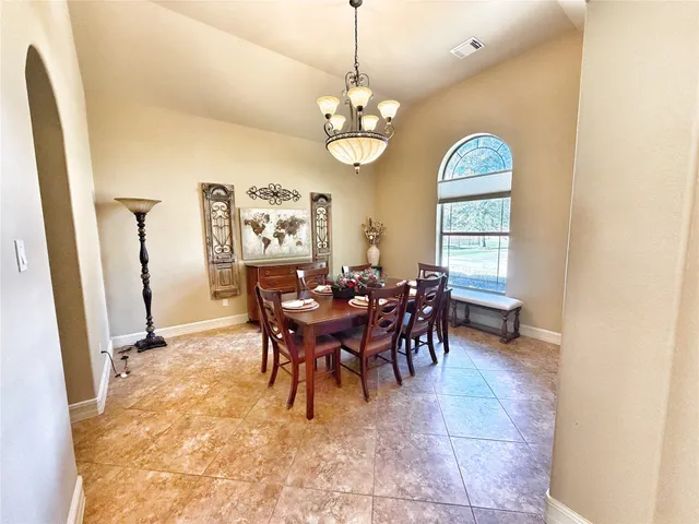 a dining room with furniture and window