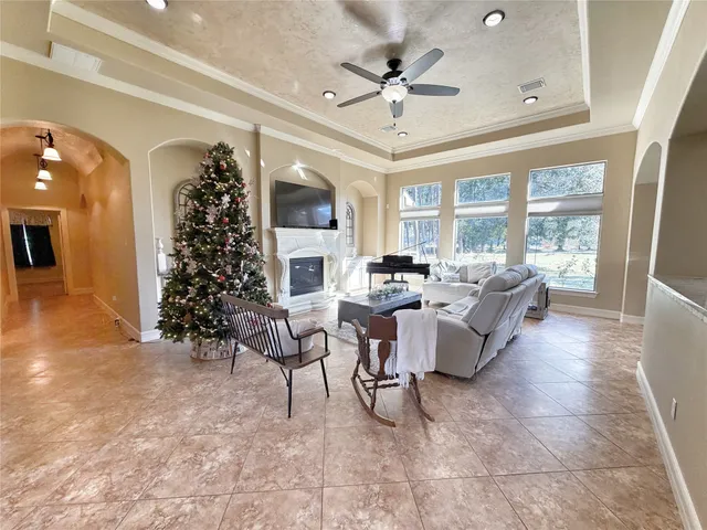 a view of a dining room and livingroom with furniture wooden floor a chandelier