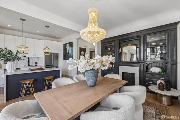 a kitchen with a dining table chairs stainless steel appliances and cabinets