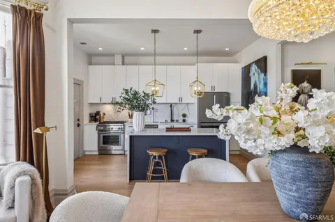 a kitchen with stainless steel appliances granite countertop a sink a refrigerator and a wooden cabinets