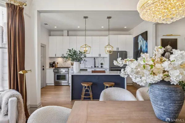 a kitchen with stainless steel appliances granite countertop a sink a refrigerator and a wooden cabinets