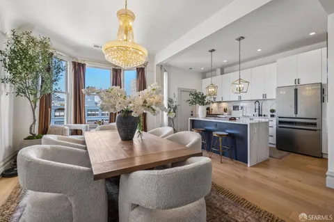 a kitchen with stainless steel appliances granite countertop a stove and a white cabinets