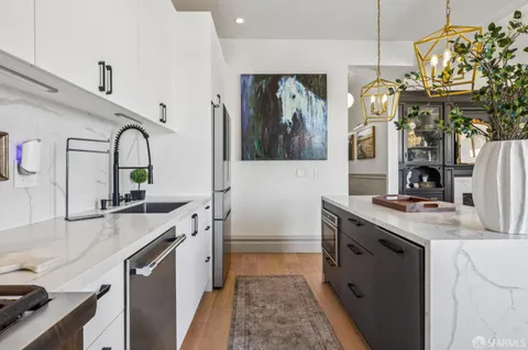 a kitchen with stainless steel appliances a refrigerator and cabinets
