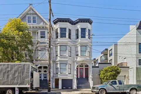 a living room with furniture a chandelier and a fireplace