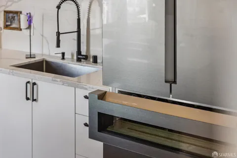 a bedroom with a bed mirror and a window