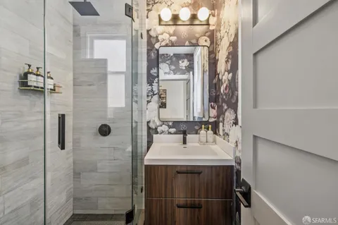 a bedroom with a bed potted plant on the dresser and a large window