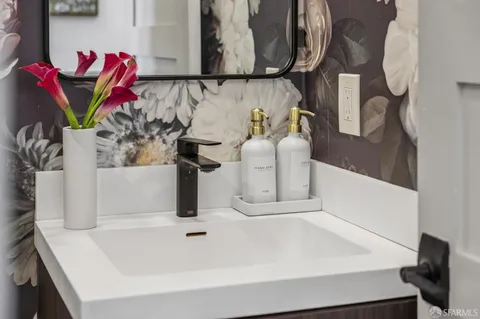 a view of a patio with table and chairs potted plants and barbeque grill