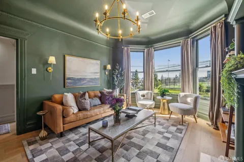 a living room with furniture and a book shelf