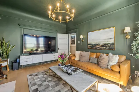 a living room with furniture and a mirror