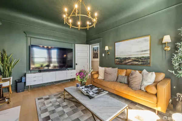 a living room with furniture and a mirror