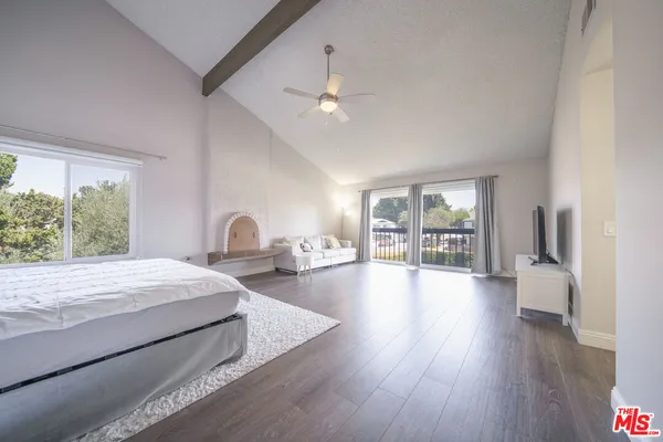 a bedroom with a large bed and a large window