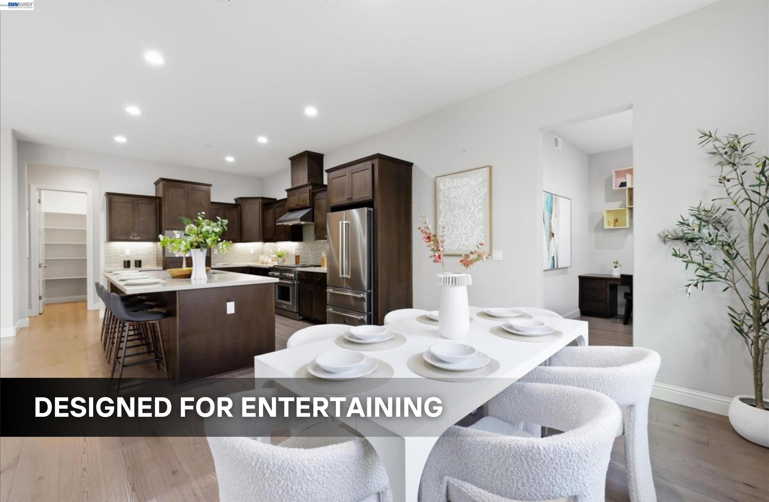 39438 Humpback Whale Road Newark, CA 94560 - Photo 14 of 51 a kitchen with stainless steel appliances kitchen island granite countertop a refrigerator a sink a stove a dining table and chairs