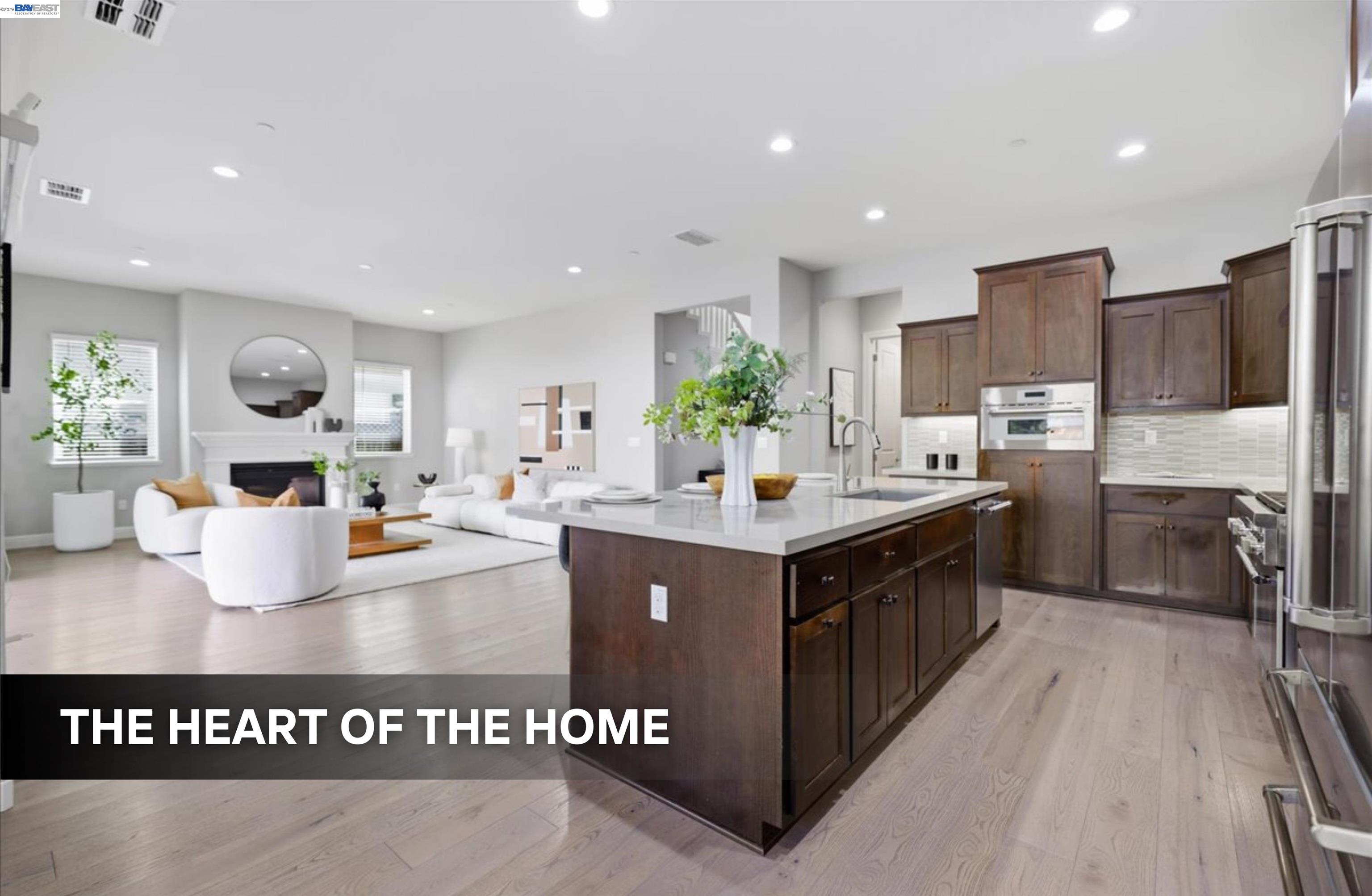 39438 Humpback Whale Road Newark, CA 94560 - Photo 9 of 51 a kitchen with stainless steel appliances granite countertop a stove a sink dishwasher and a refrigerator with wooden floor
