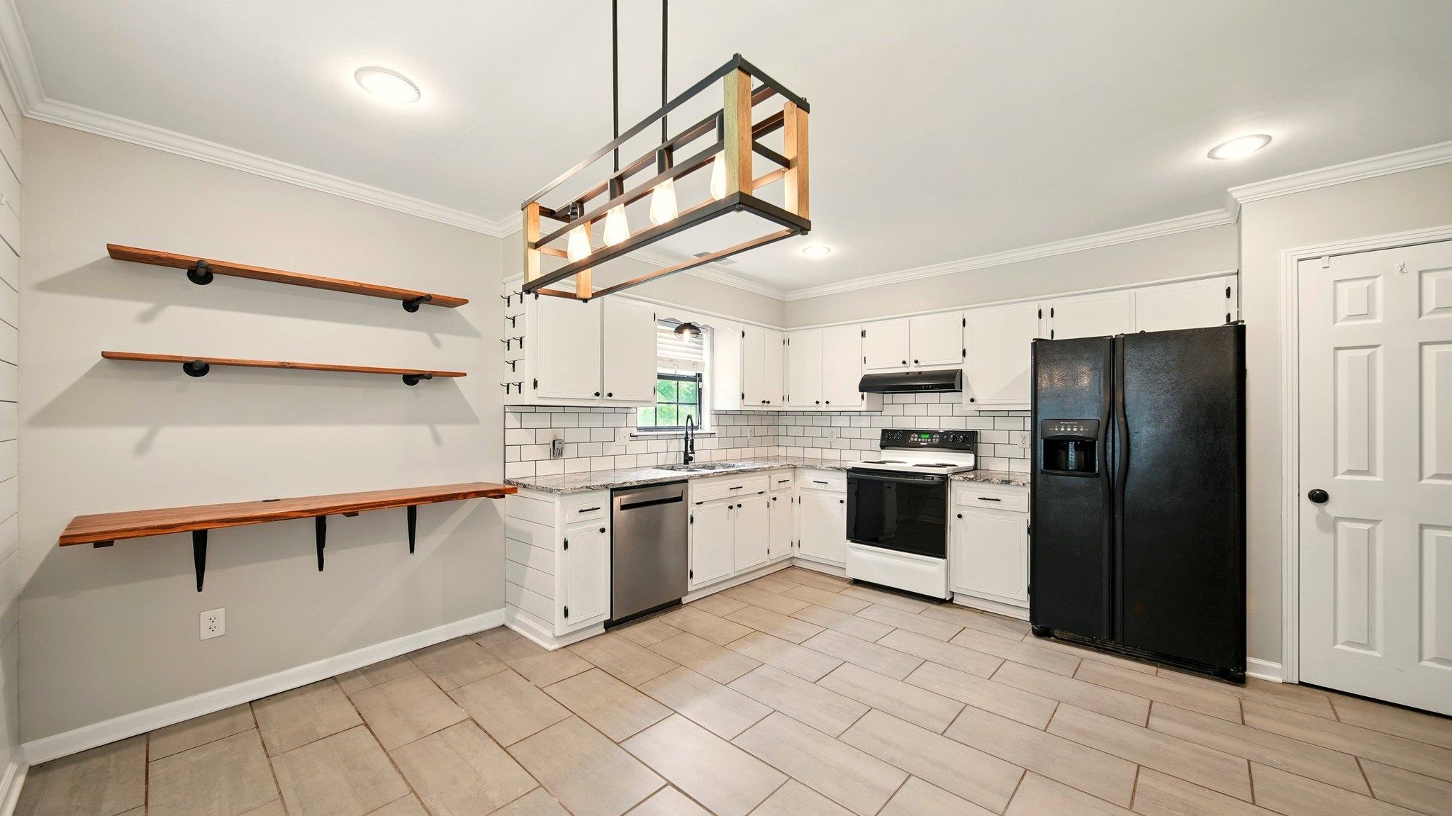 979 Ray Bluff Road Millington, TN 38053 - Photo 1 of 21 Kitchen featuring black refrigerator, electric range, stainless steel dishwasher, a sink, and under cabinet range hood