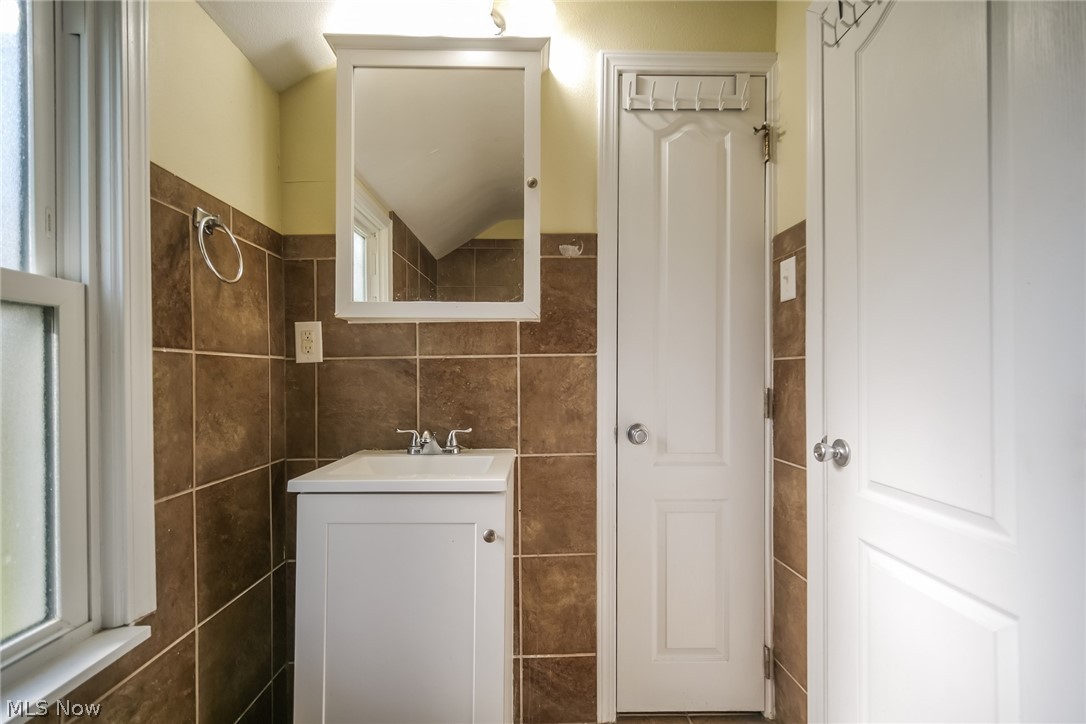 736 Quilliams Road Cleveland Heights, OH 44121 - Photo 13 of 20 Bathroom featuring tile walls and vanity