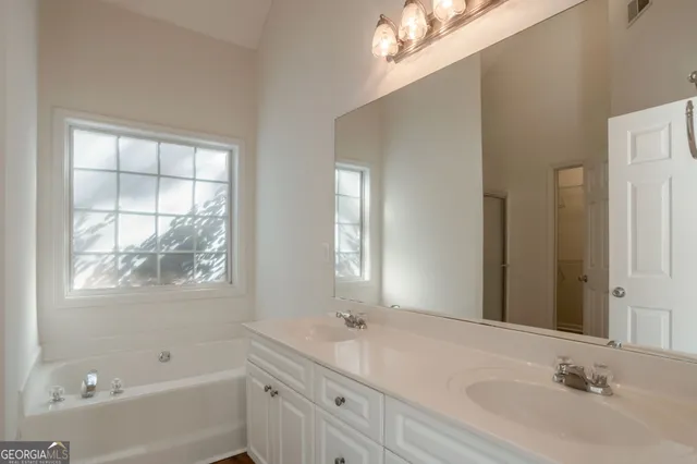 a bathroom with a bathtub and a sink