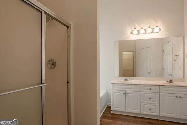 a bathroom with a double vanity sink and a mirror