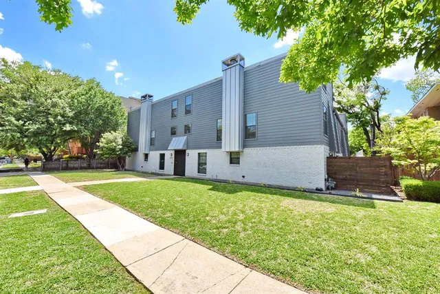 a front view of house with yard and trees
