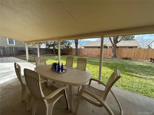 a view of a porch with furniture and backyard