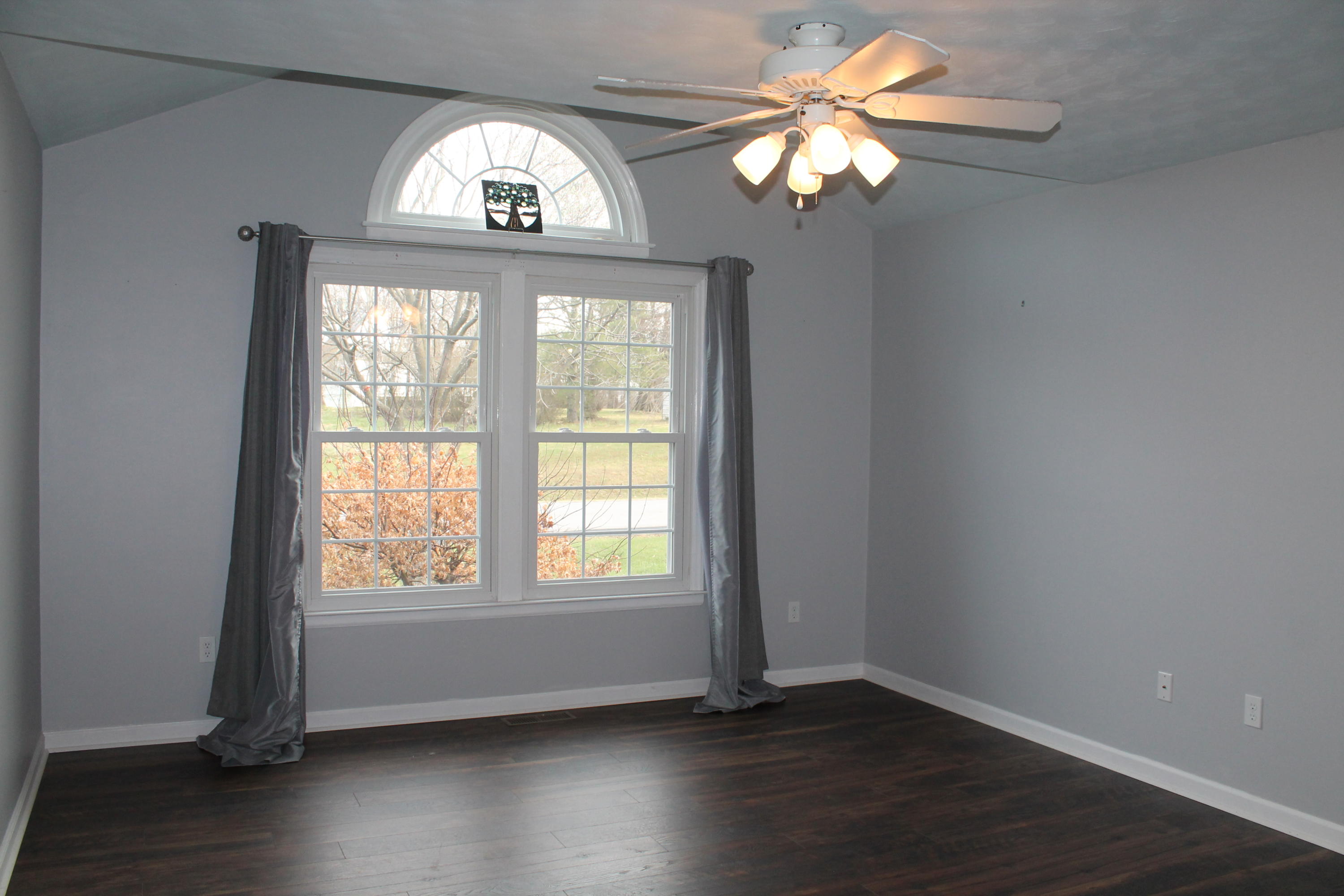 101 Aftons Meadow Road Vinton, VA 24179 - Photo 5 of 55 an empty room with wooden floor fan and windows