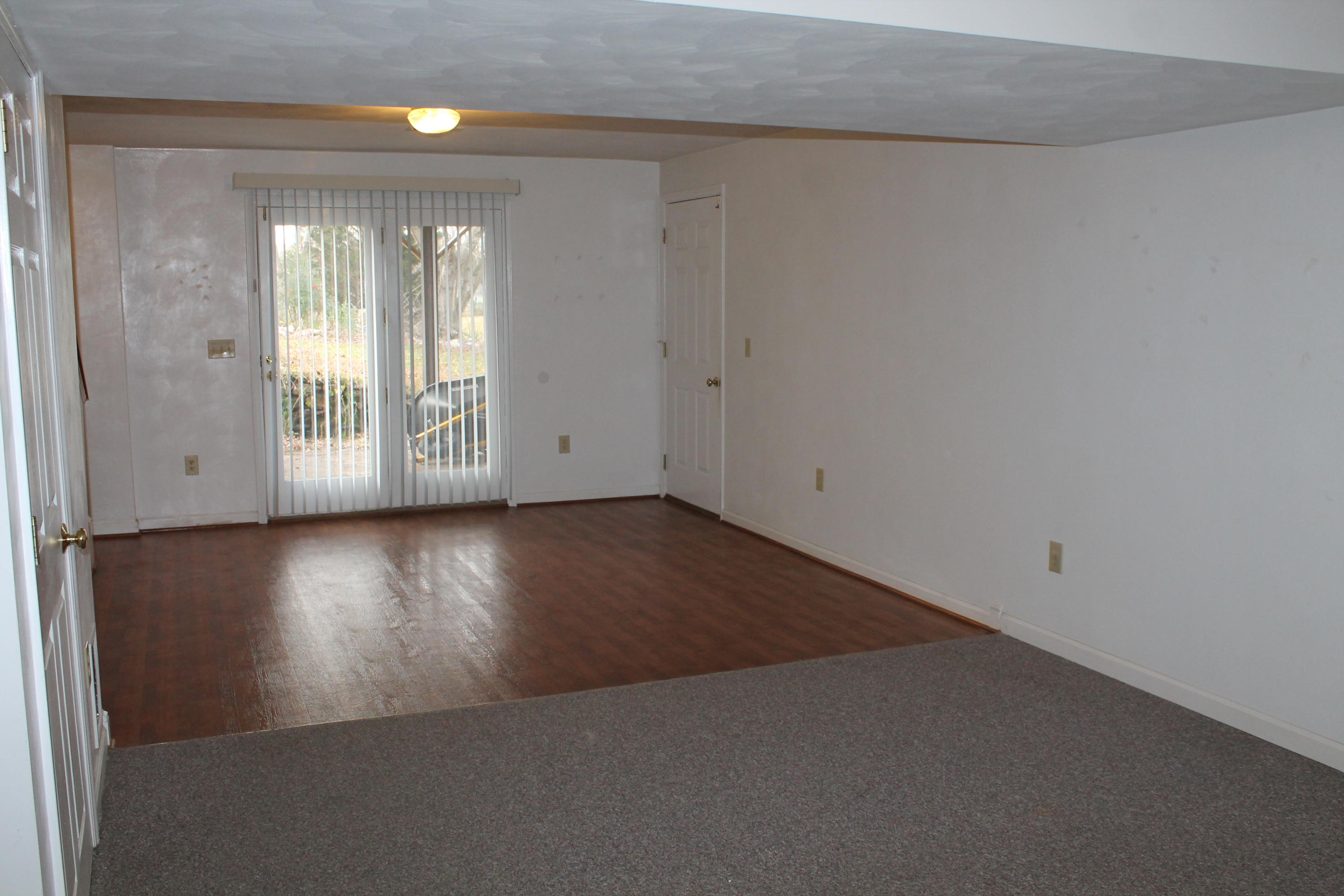 101 Aftons Meadow Road Vinton, VA 24179 - Photo 46 of 55 an empty room with wooden floor and windows with curtains