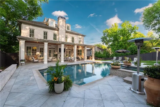 a view of a house with sitting area and potted plants