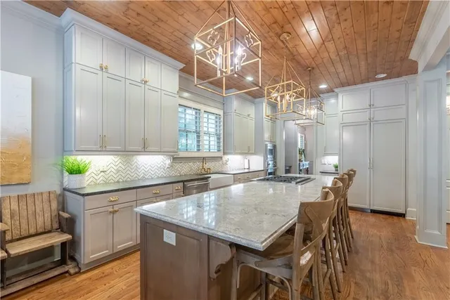 a kitchen with a table chairs and wooden floor