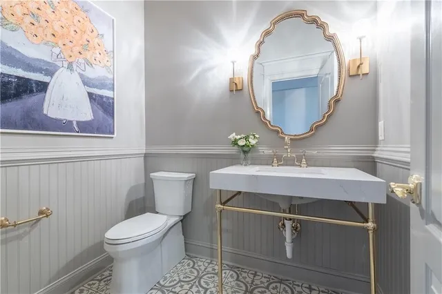 a bathroom with a sink mirror and toilet