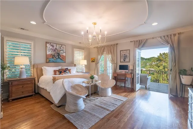 a bed room with wooden floor and windows