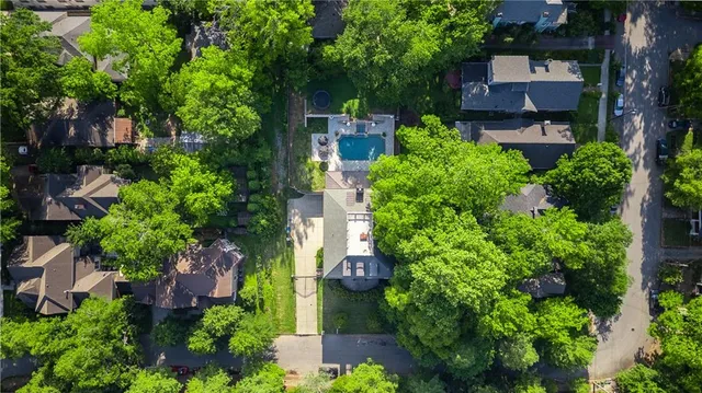 an aerial view of a house with garden space and street view
