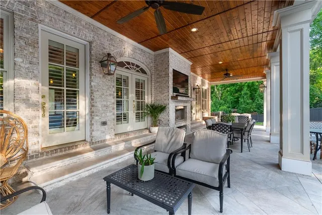 a dining room with furniture and a potted plant