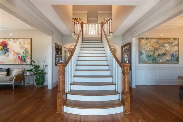 a view of entryway and hall with wooden floor