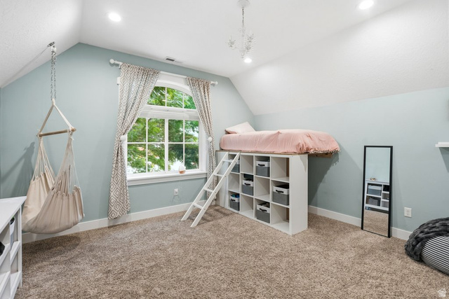 672 Perry Hollow Drive Mapleton, UT 84664 - Photo 61 of 106 Vaulted ceiling room featuring a large arched window, built-in shelving, recessed lighting, and carpet flooring