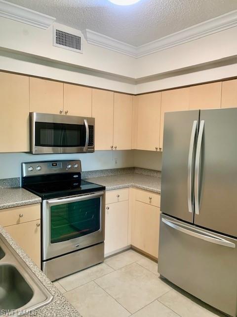1180 Reserve Way, Unit 206 Naples, FL 34105 - Photo 2 of 22 a kitchen with granite countertop a refrigerator and a stove top oven