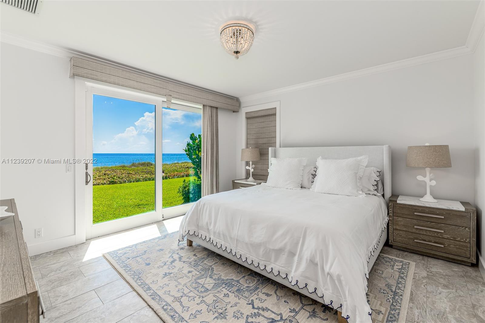 25 South Beach Road Hobe Sound, FL 33455 - Photo 28 of 34 a bedroom with a bed and a large window