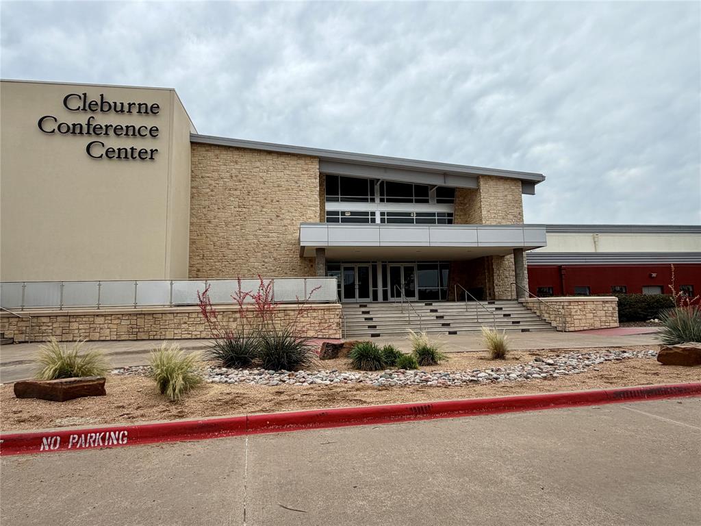 619 Mansfield Road Cleburne, TX 76031 - Photo 18 of 19 Modern conference center entrance featuring a stone facade and expansive windows located directly across from the senior citizens center and in the same parking lot as the Visitors Bureau